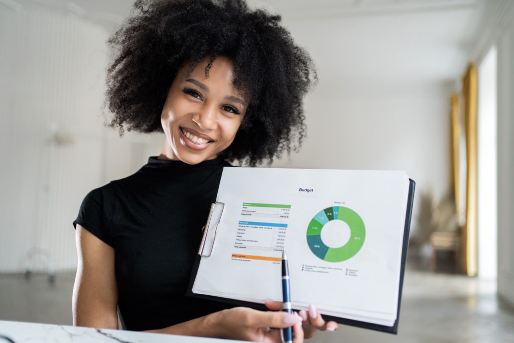 woman holding finance report showing her financial goals