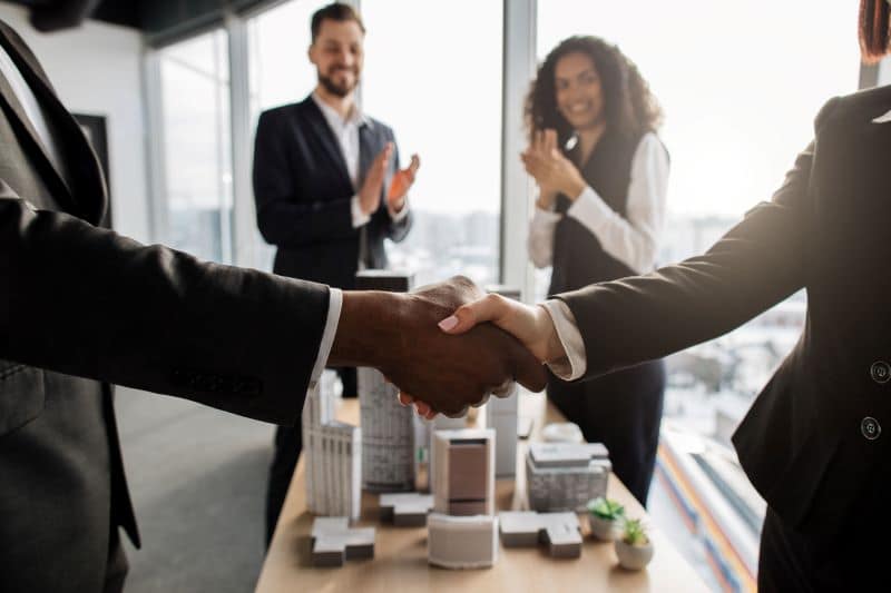 Business people shaking hands during a M&A